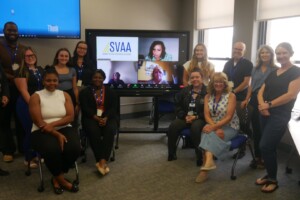 A group of people sitting in front of a tv.