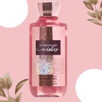 A pink bottle of shower gel on top of a pink background.