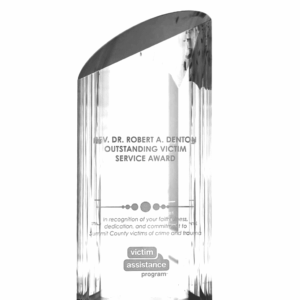 A clear glass trophy with the words " victory assurance " on it.